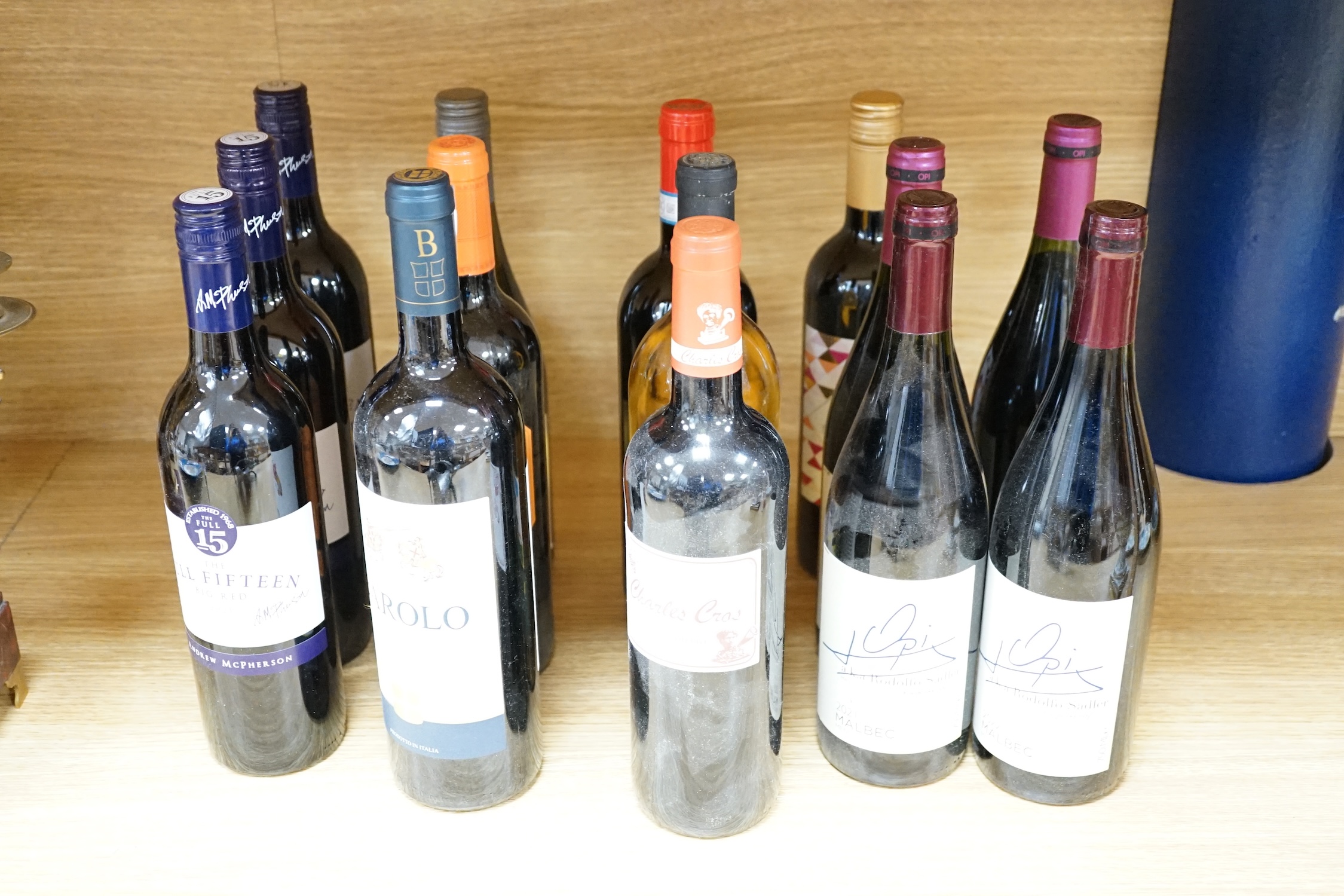 A collection of eighteen bottles of wine together with a pewter bottle holder/pourer